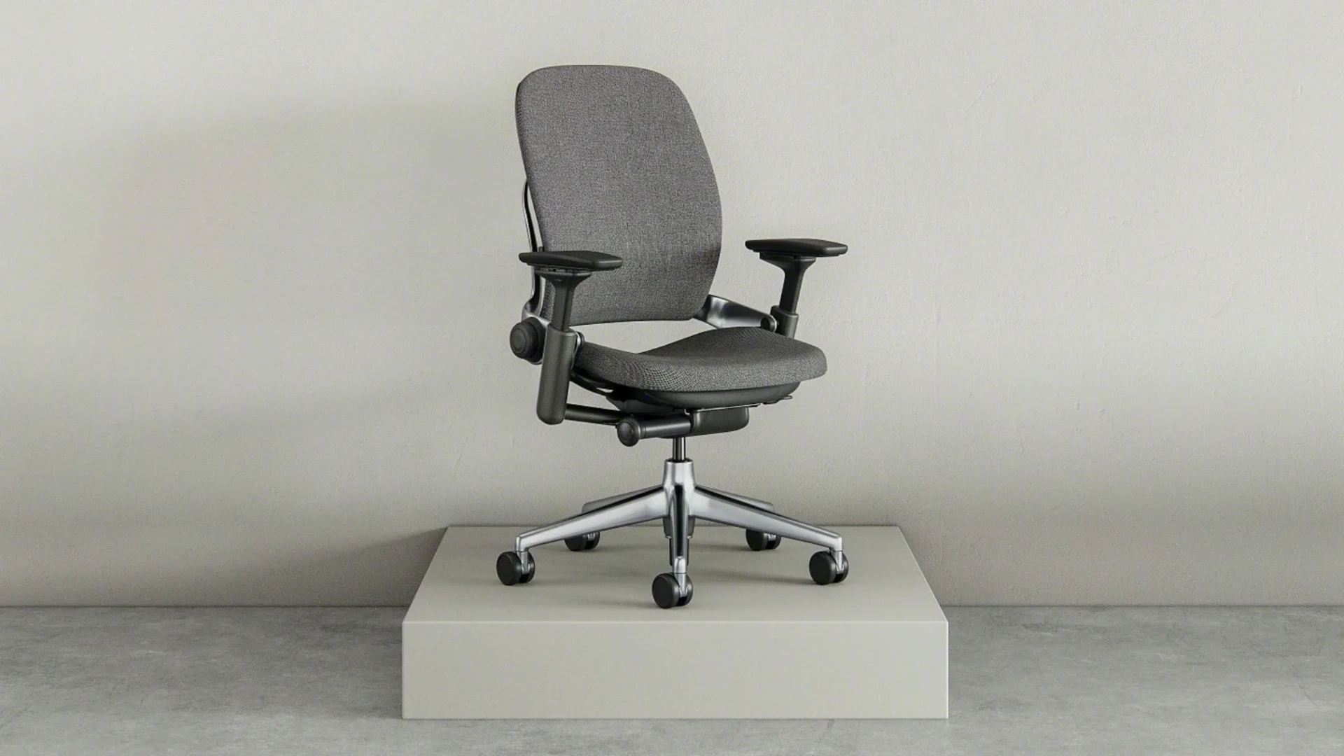 Steelcase Leap Plus office chair in black fabric, showing full chair with high back, adjustable arms, and reinforced 5-star base